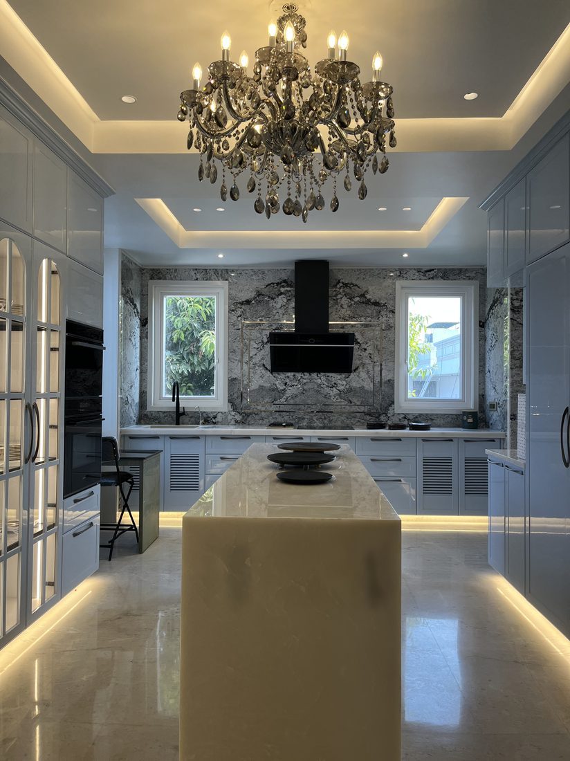 The Civil Lines Kitchen &mdash; marble island kitchen with chandelier